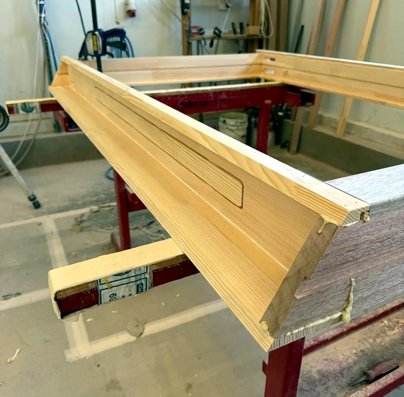 Close-up of a brass sash pulley routed into a white timber sash window