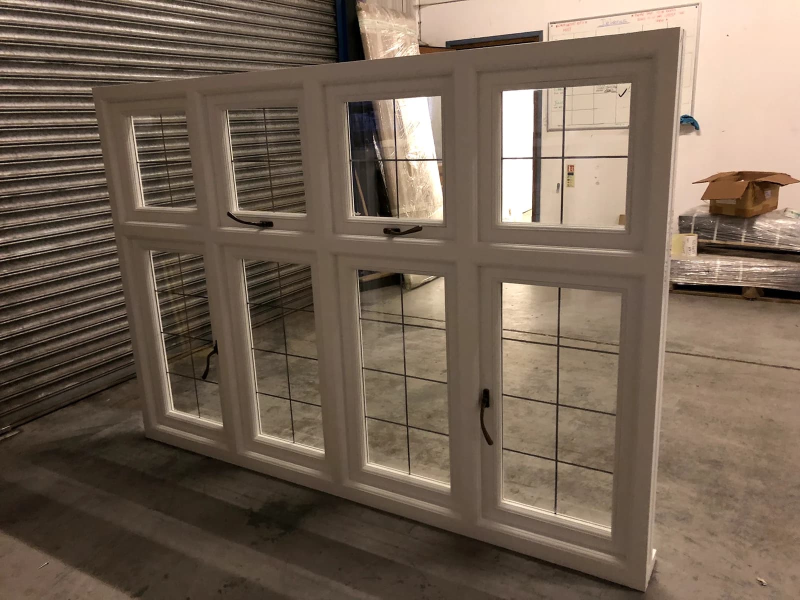 Edwardian timber casement windows with leaded top lights over larger clear panes, in a cream finish