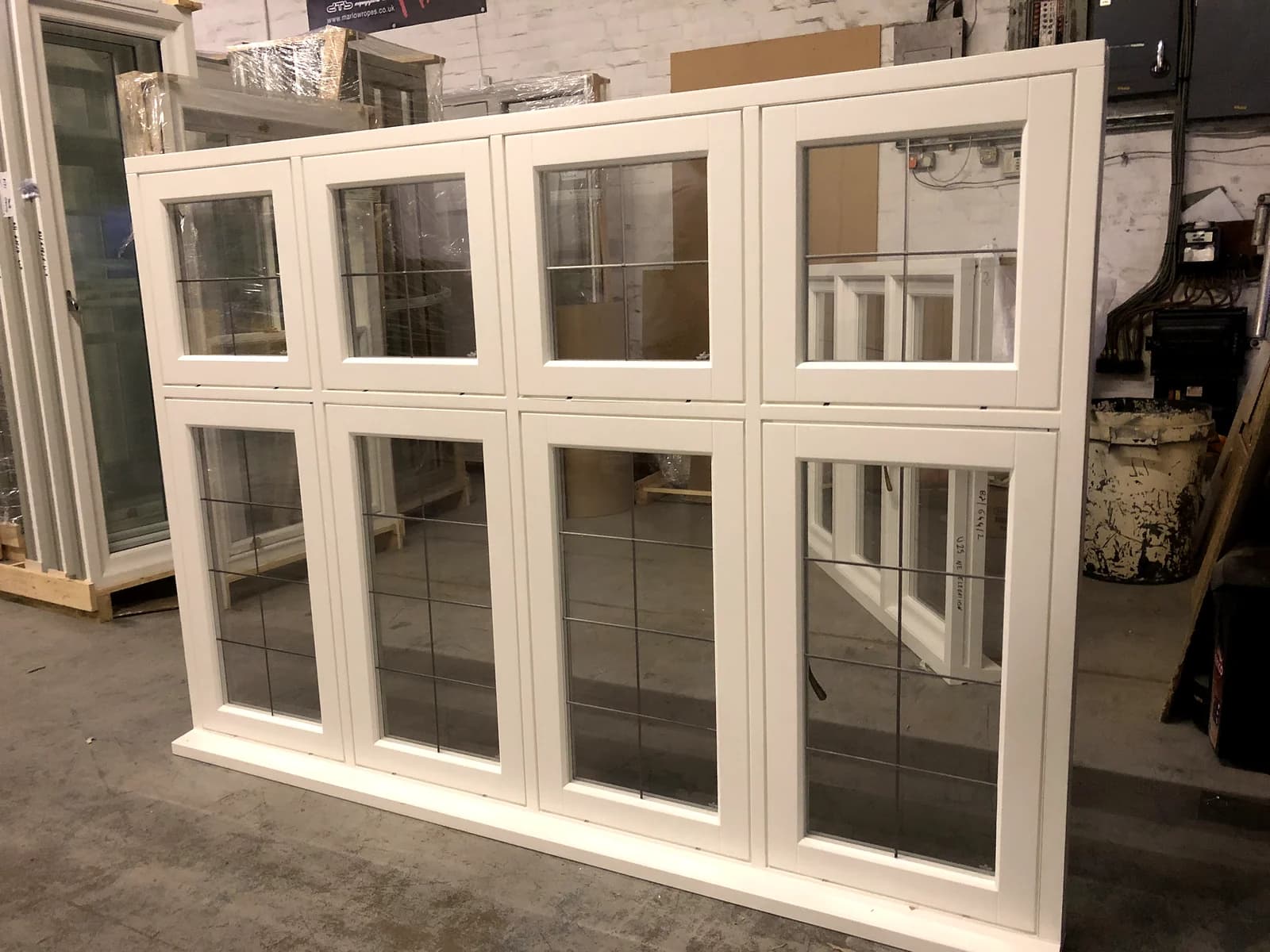 A run of Edwardian timber casement windows with leaded lights and multi-pane top lights