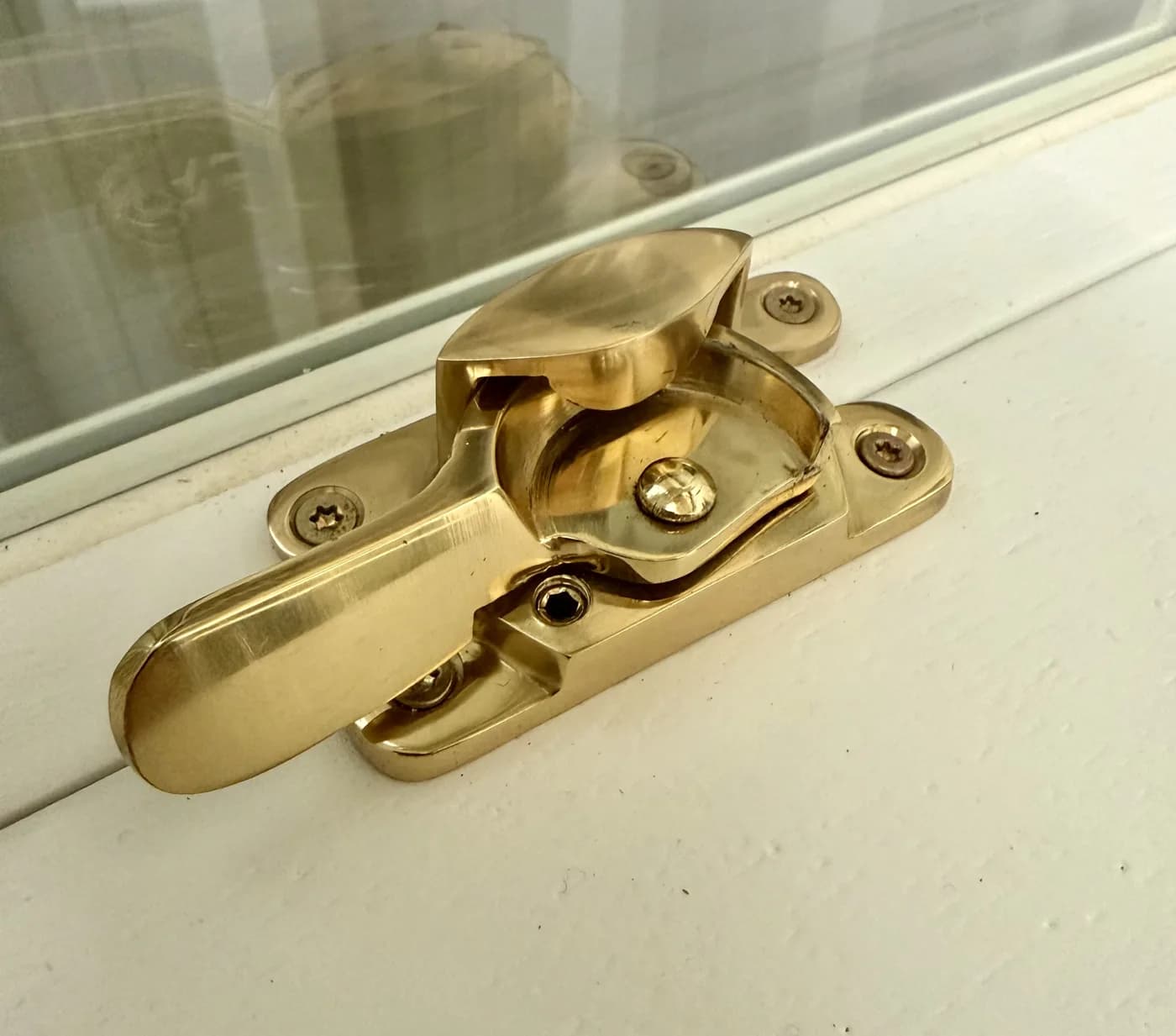 Polished brass fitch fastener on the meeting rail of a timber sash window