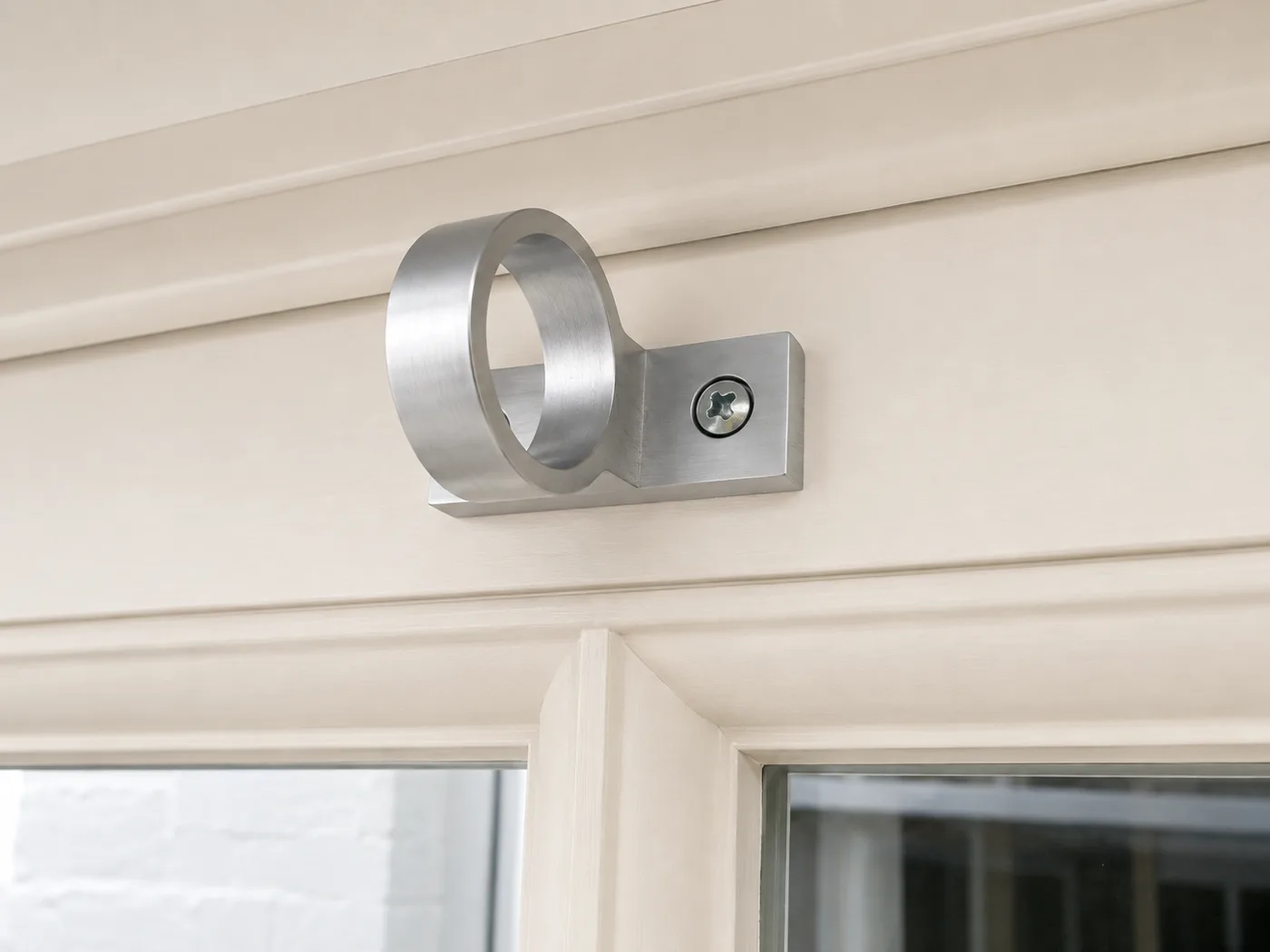 Satin chrome ring pull on the top rail of a timber sash window