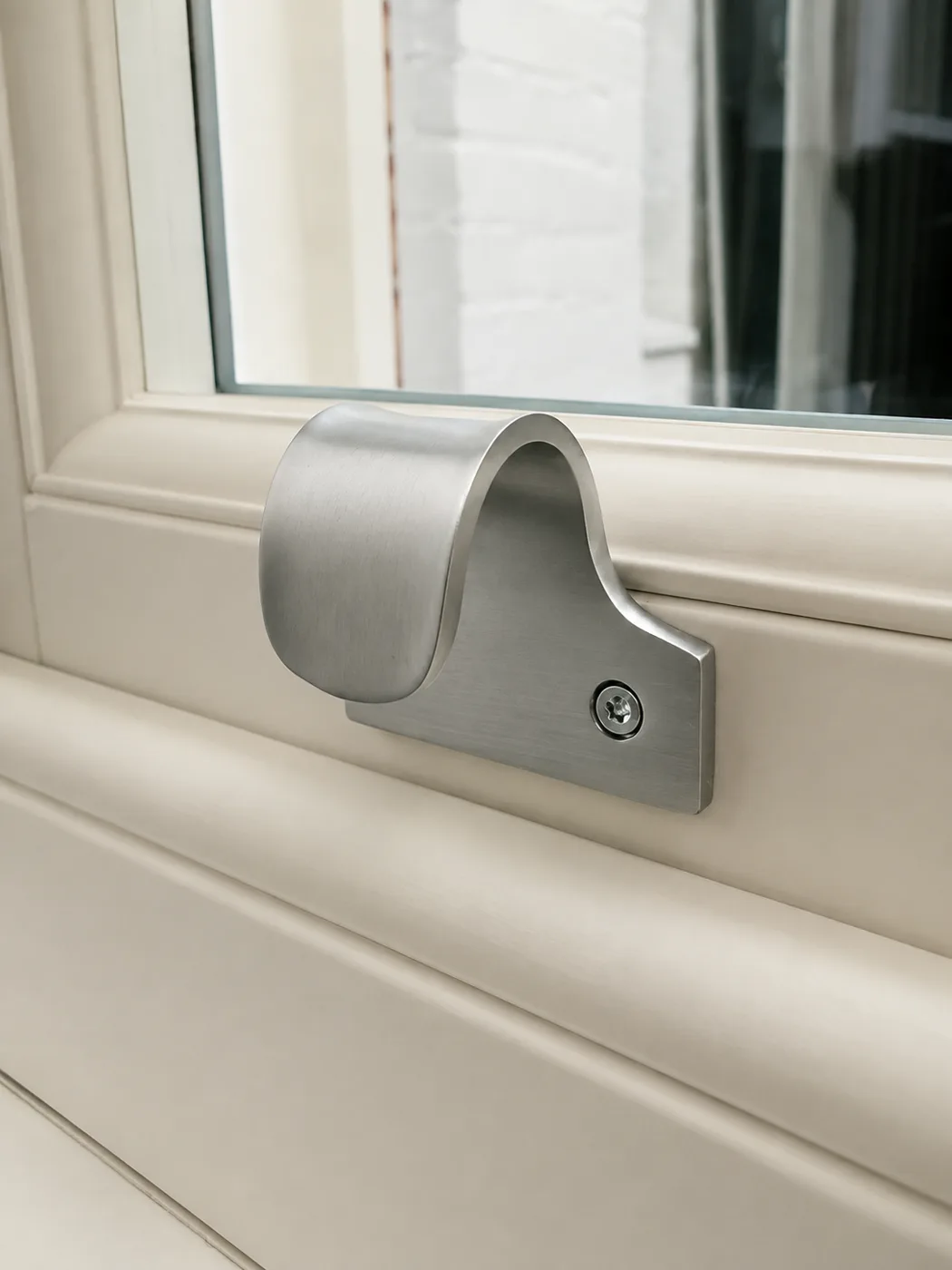 Satin chrome sash lift fitted to a painted timber sash window
