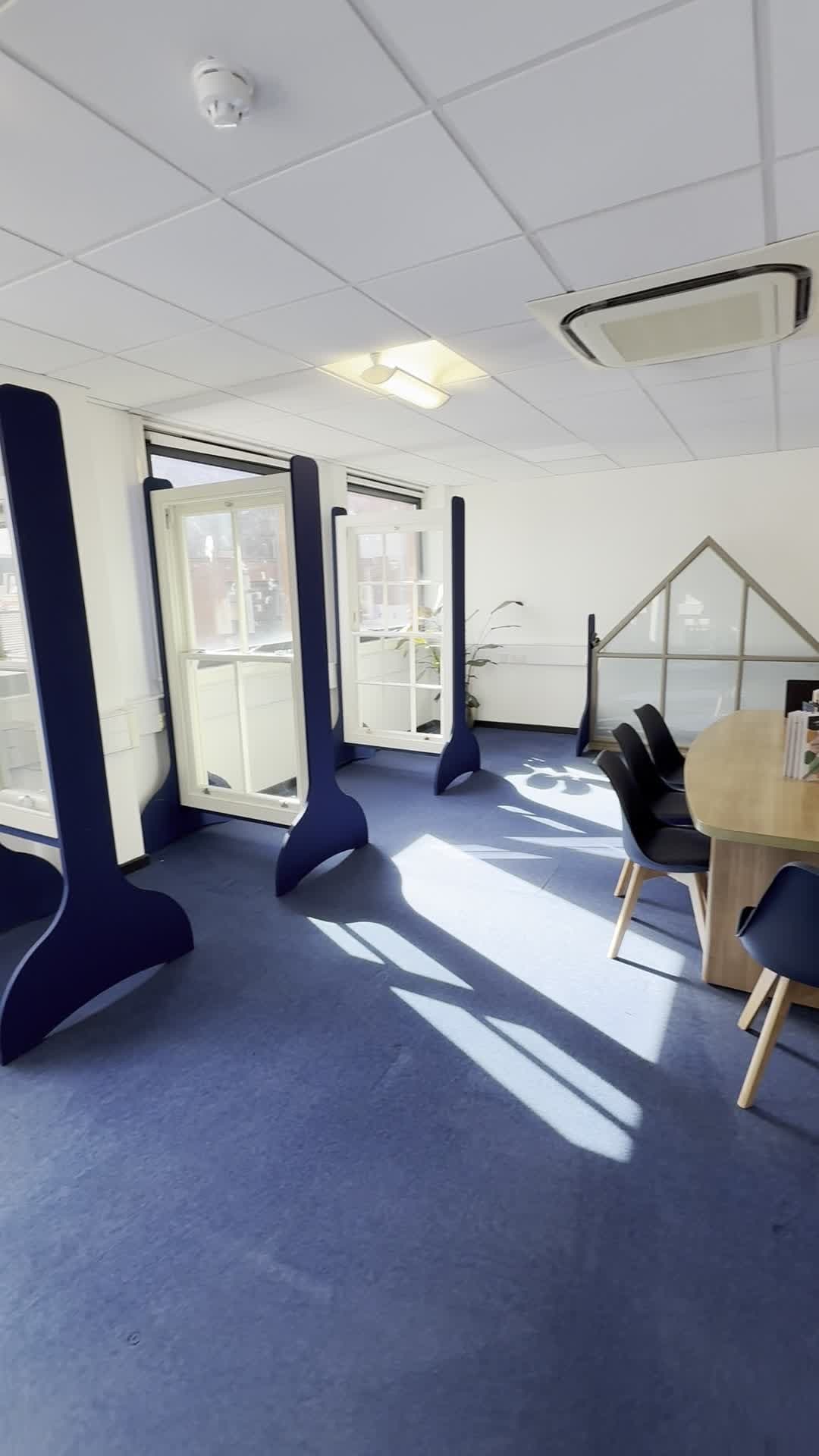 The showroom: sash windows on display stands beside the windows, with a table to go through your project